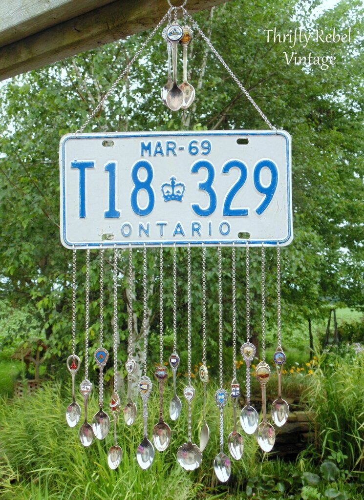 licsence plate hanging with spoons attached with chains as a windchime 