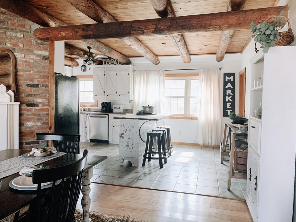 farmhouser kitchen with beams and white cabinets 