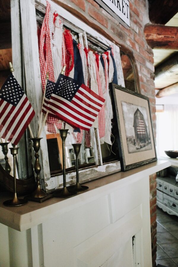 AMERICAN FLAGS AND SCRAP FABRIC BANNER ON MANTLE