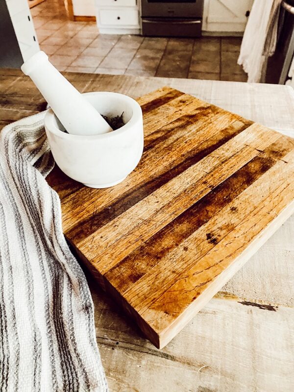 wood cutting board with marble mortar and pestle