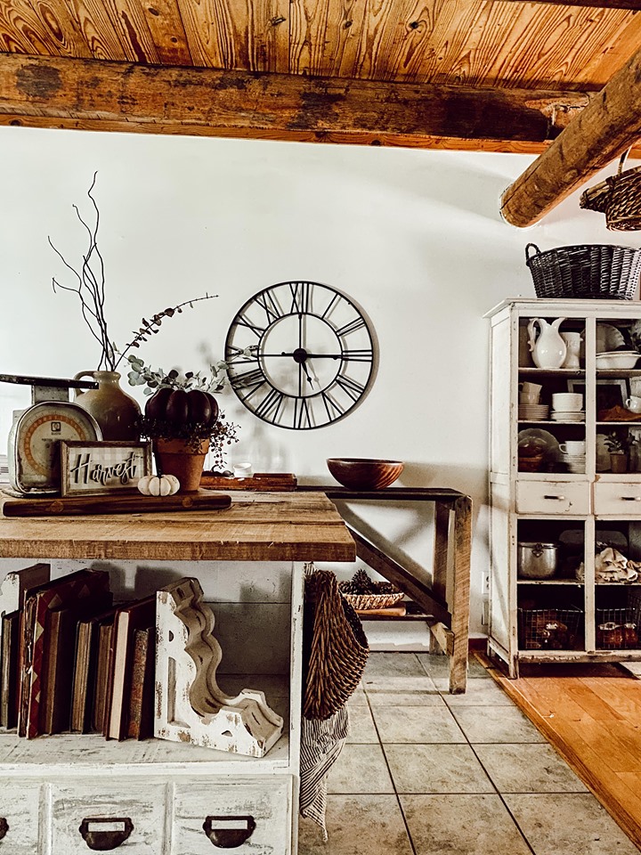 rustic fall vignette with warm tones and large metal clock