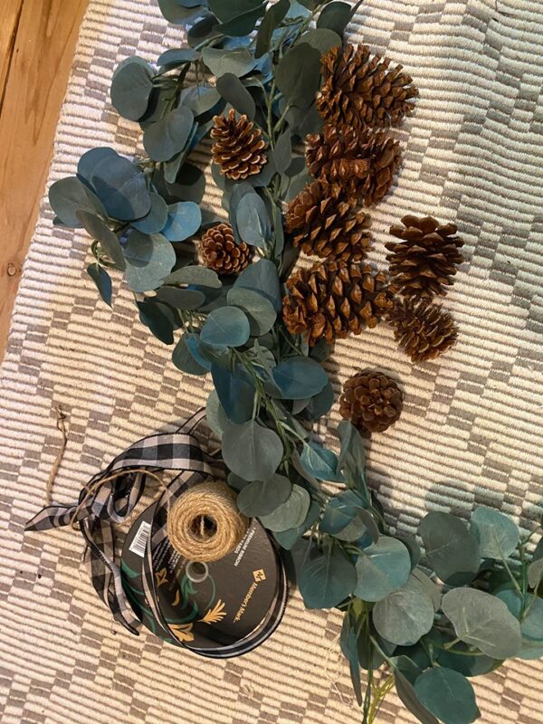pine cones and buffalo check ribbon with eucalyptus
