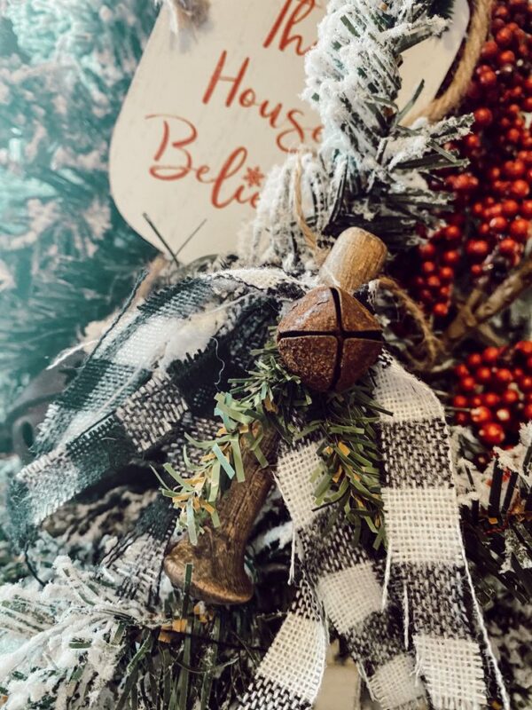 rustic wood peg ornament with rusty bell and scrap buffalo check ribbon