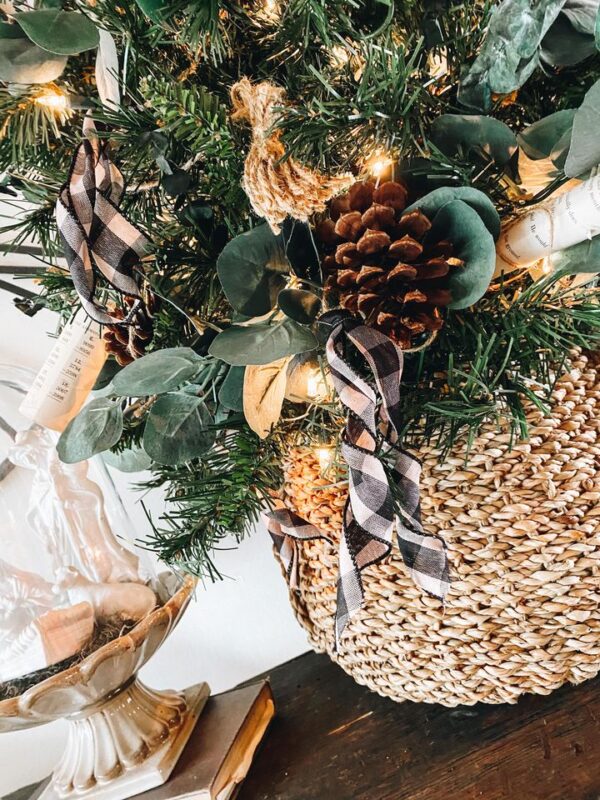 Wicker basket and DIY nativity set styled next to rustic eucalypotus christmas tree