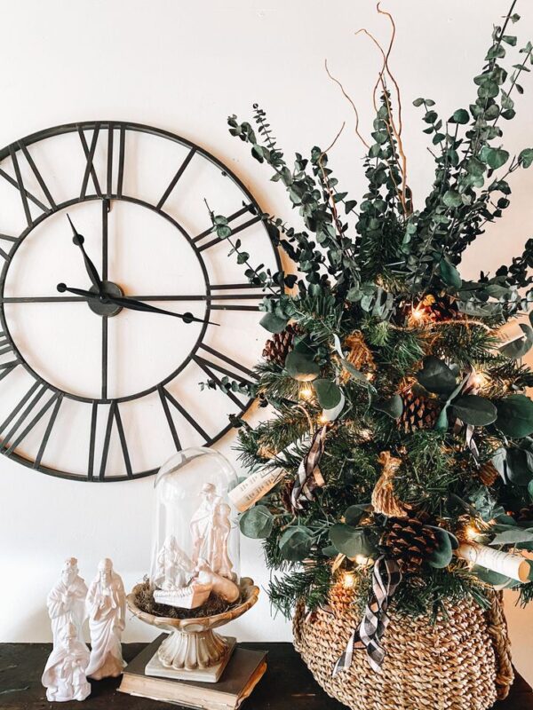 beautiful Christmas tree with DIY eucalyptus garland and old book pages 