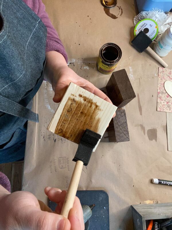 wood block being stained for Valentine's Day craft