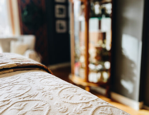 old fashioned bedding with curio cabinet